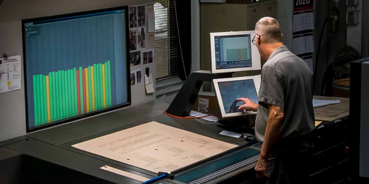A press operator adjusts the color setting on the offset printer at Keefer Printing.