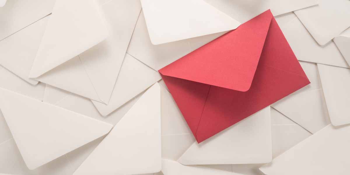 A red printed envelope on a background of white envelopes. A red printed envelope on a background of white envelopes.