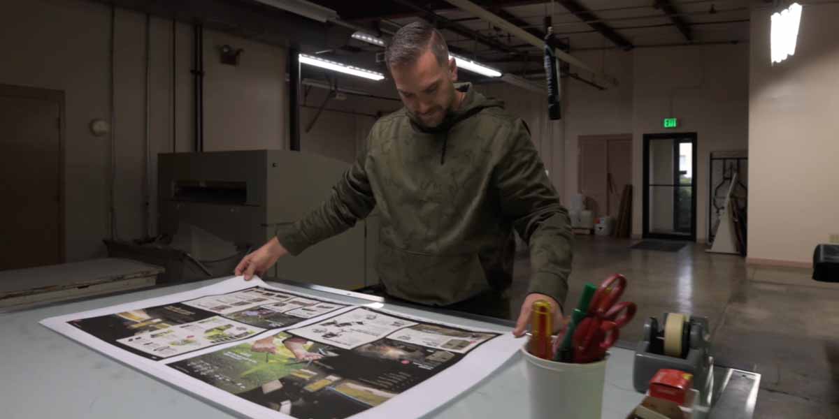 A worker checks a press sheet at Keefer Printing